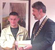 Winner of the Lions Club Youth Award 2000, Ross O'Connor being presented with his prize by Brendan Fitzgerald, President of Tralee Lions Club