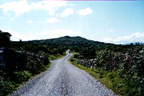 A quiet country road with the Bunnagippaun hill in the background