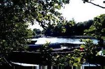 Fishing boats moored along the banks of the Owenriff River, near the boat-house at Oughterard.